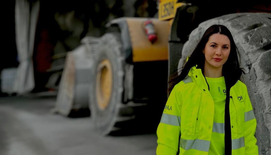 Medarbetare i skyddskläder vid tung anläggningsutrustning i projektet vid Gullmarsplan. Bilden togs i en säker, avstängd miljö utan pågående arbete, där ordinarie skyddsutrustning tillfälligt togs av enbart för fotograferingen. Fotot lyfter OHLA Sveriges satsning på ökad jämställdhet och fler kvinnor i byggbranschen. Pressbild: OHLA