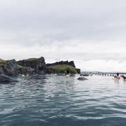 Sky Lagoon på Island. Turister som njuter av ett geotermiskt spa med uppvärmt vatten under en kall dag. Av: Renata Tyburczy